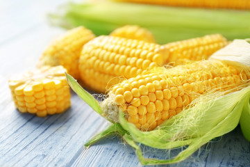 Fresh corn cobs on wooden table