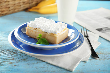 Plate with tasty banana cake on wooden table