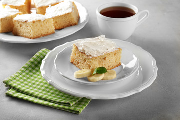 Plate with tasty banana cake on table
