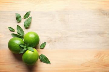 Composition with lime and mint on wooden background