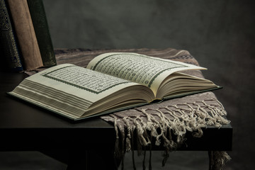 Koran - holy book of Muslims ( public item of all muslims ) on the table , still life