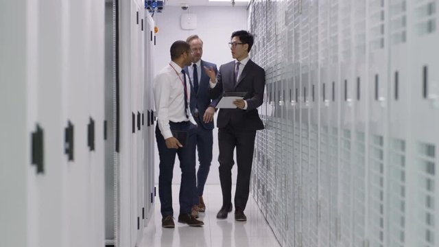 Business team in a meeting, discussing the servers in a data center.