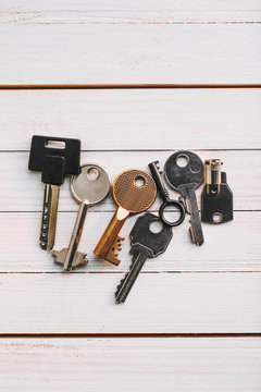 Some keys on wood white background.