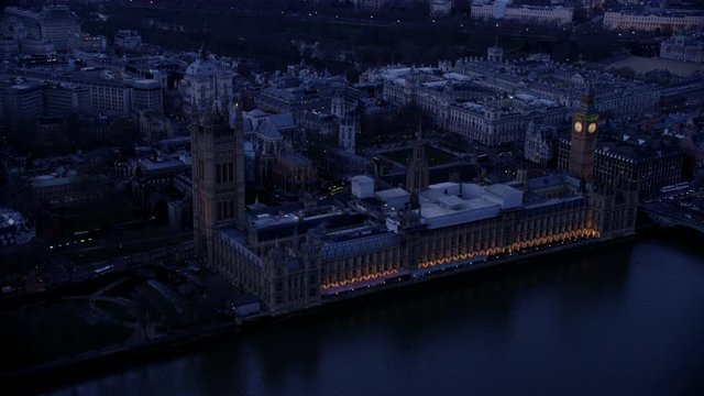  Aerial view of London's Big Ben & Houses of Parliament lit up in early morning 