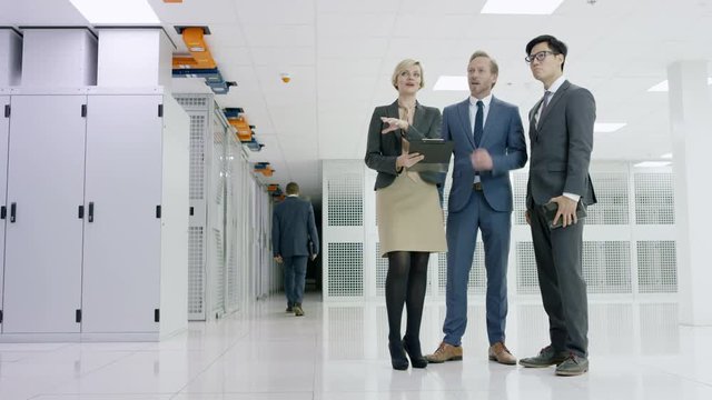 Business team in a meeting, discussing the servers in a data center.