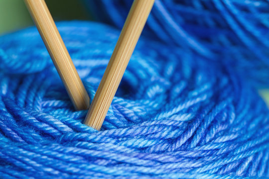 Macro of wooden knitting needles in spool of yarn