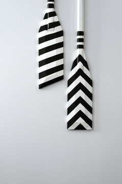 Boat Oars Painted In Black And White, Hanging On A Wall As Decoration