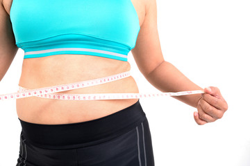 chubby  woman measuring her waistline