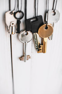 Some keys hanging on white.