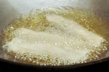Cooking spring roll as four sheet wrap  fried vermicelli and sliced cabbage in roll bar.