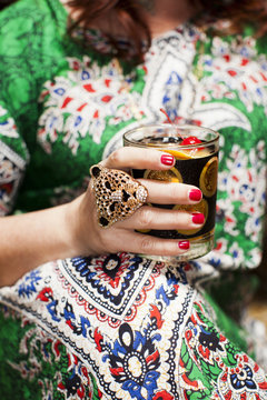 Woman Holding Drink at Seventies Party