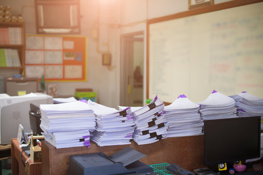 Pile of unfinished documents on office desk with business office  background