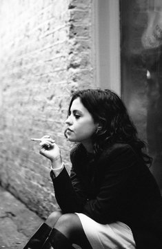 Beautiful young woman smoking a cigarette