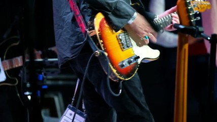Pan playing electric guitar at live concert