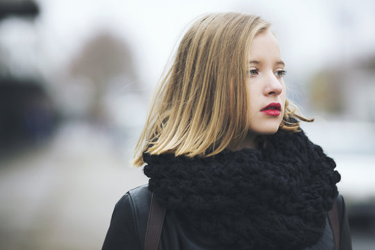 Portrait of young woman wearing black infinity scarf