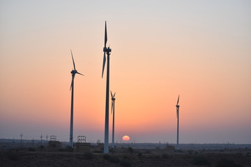 sunrise  with modern wind mills in great thar desert jaisalmer rajasthan india