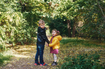 Brother and sister walking in an autumn Park