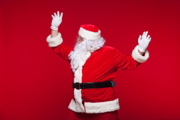 Santa Claus is dancing Isolated on red background.