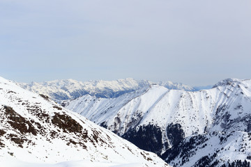 Fototapeta na wymiar Mountain panorama with snow, trees and blue sky in winter in Stubai Alps, Austria