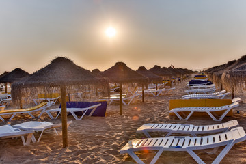 Empty sunshades and chairs at the beach