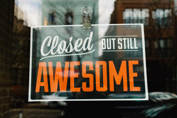 closed for business sign in window