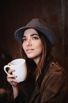 Beautiful and stylish woman holding a cup of coffee