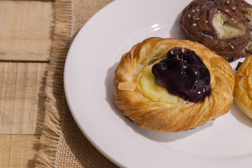 a variety of bakery on wooden plate