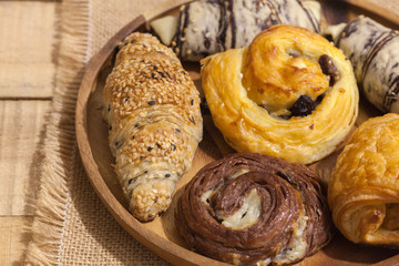 a variety of bakery on wooden plate