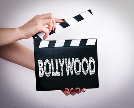 Bollywood. Female Hands Holding Movie Clapper. White Background