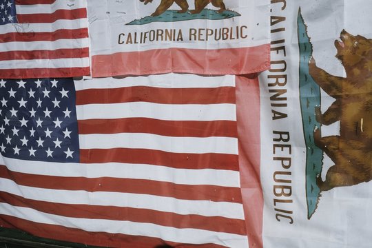 American flags and the flag of California cover a window