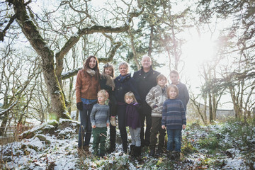 Happy grandparents enjoying their grand children outside in winter - family portrait