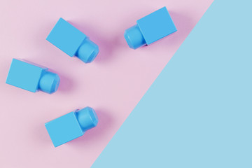 Blue plastic construction blocks on pink and blue background