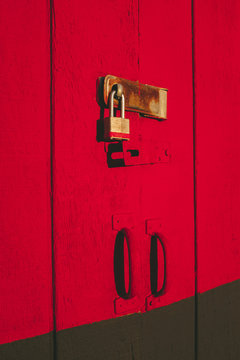 Padlock on brightly colored building door
