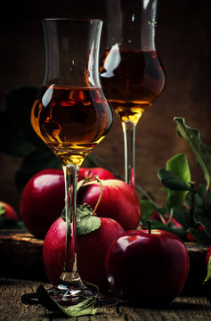 French strong golden alcohol drink from apples, rustic still life, selective focus