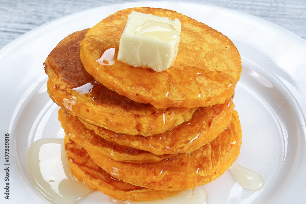 Wall mural stack of pumpkin pancakes with honey and butter