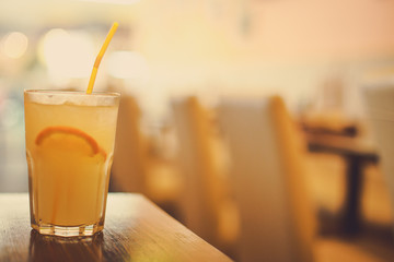 glass of juice and a slice of Orange and straw