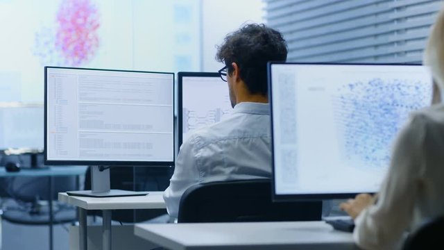 Team of Talented Computer Engineers Programming at Their Workstations. Independent Company Works on a Neural Network Machine Learning Development Project