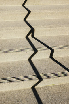 Shadows from handrail on urban steps