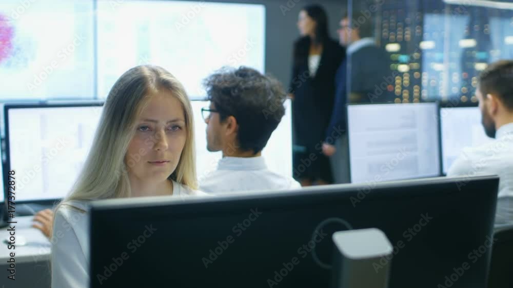 Aufkleber Female Computer Engineer Works on a Neural Network/ Artificial Intelligence Project with Her Multi-Ethnic Team of Specialist. Office Has Multiple Screens Showing 3D Visualiation.