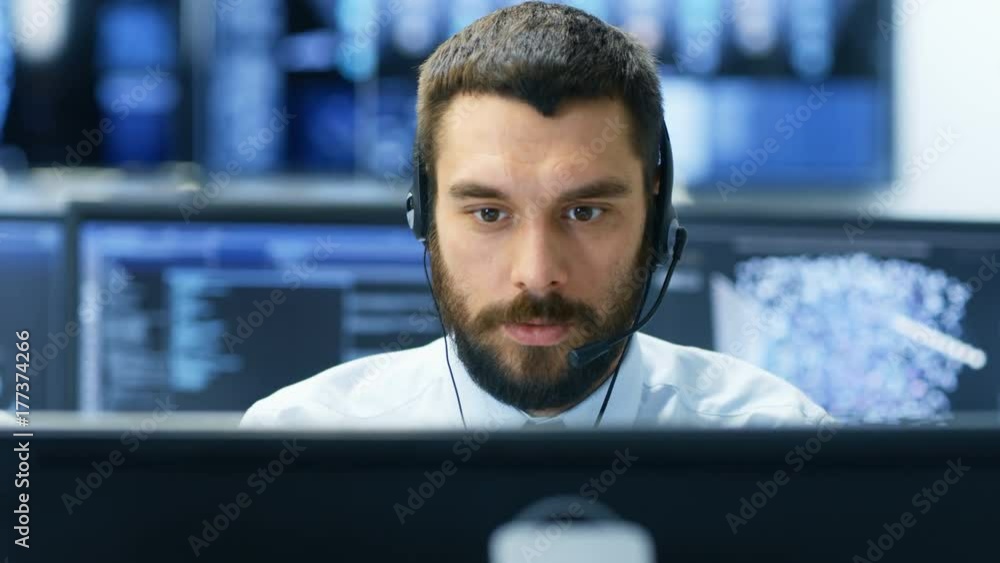 Aufkleber customer service representative answer client's questions in a headset. he works for a big technolog