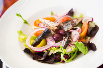 Fresh vegetable salad with pickled sardines