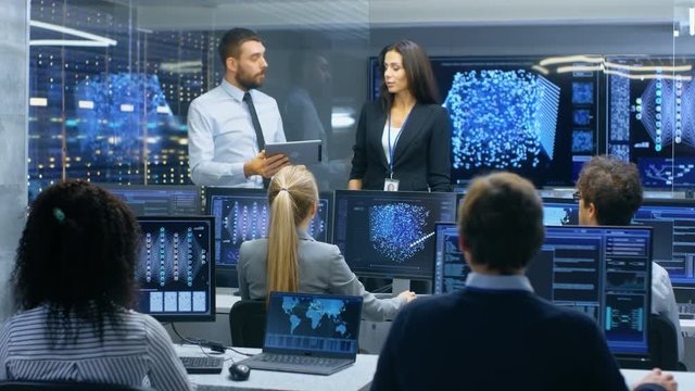Head of the Department and Project Manager Discuss Work Process Using Data on a Tablet Computer.Multi-Ethnic Team of Engineers Working at their Workstation.