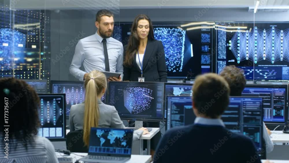 Poster Project Manager Introduces New Head of the Department. Team of Engineers and Programmers are Building Machine Learning System. Displays Show Working Model of Neural Network. 
