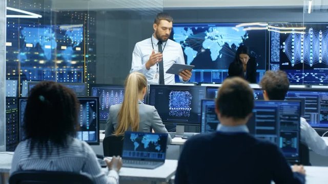 Chief Project Engineer Holds Briefing for a Team of Scientists that are Building Machine Learning System. Displays Show Working Model of Neural Network. 