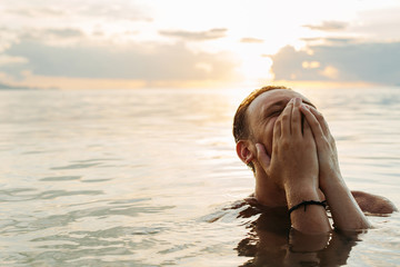 Portrait of a smiling man in the sea.