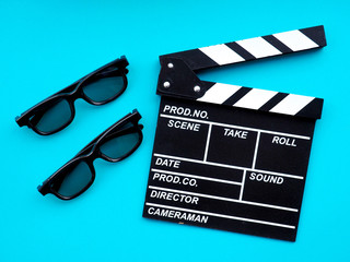 Movie clapperboard on blue background