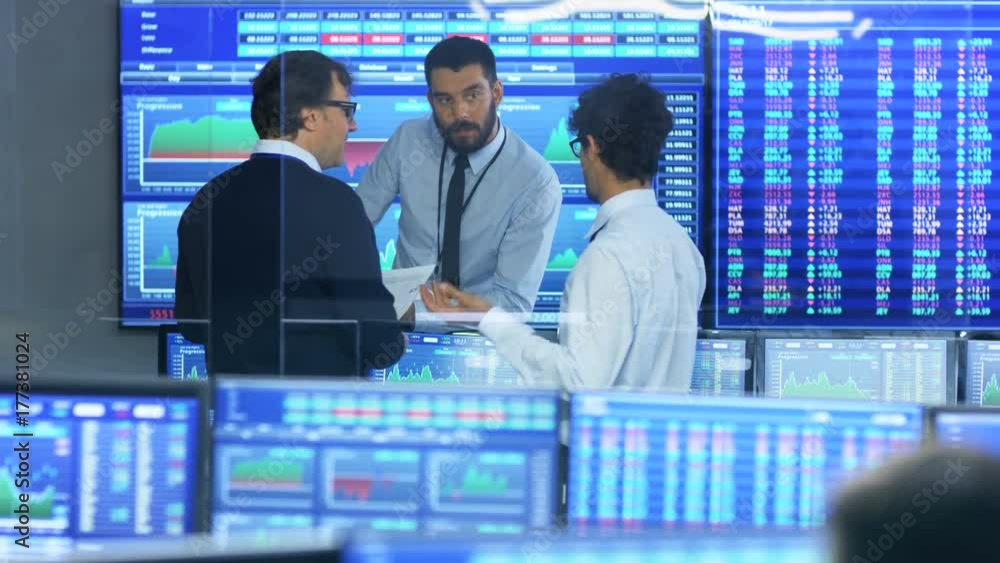 Poster three experienced stock traders talking business. they work for a big stock exchange firm. office is