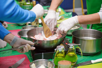 Chefs frying bacon in the pan. cooking concept