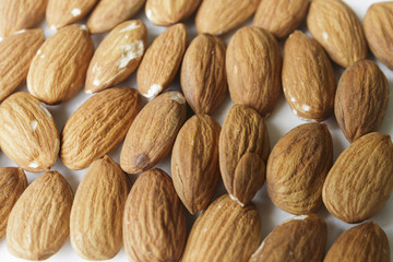 Vegan food. Raw Almond nuts for roasting closeup. Natural food background.