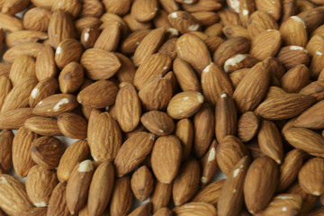 Vegan food. Raw Almond nuts for roasting closeup. Natural food background.